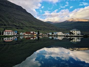 Scenic view of calm lake against cloudy sky