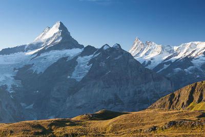 Scenic view of snowcapped mountains against clear sky