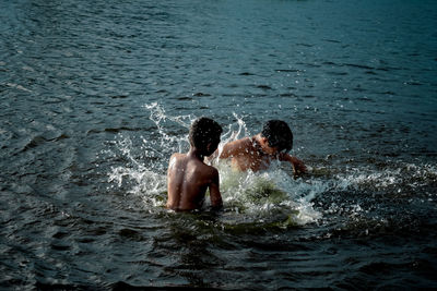 Men swimming in sea