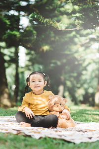 Portrait of smiling girl sitting in park