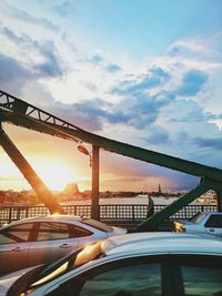 Suspension bridge against sky during sunset