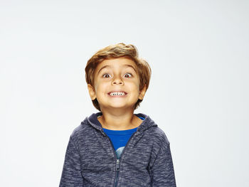 Portrait of a smiling young man against white background