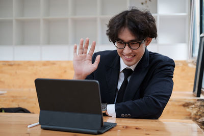 Businesswoman using laptop at desk in office