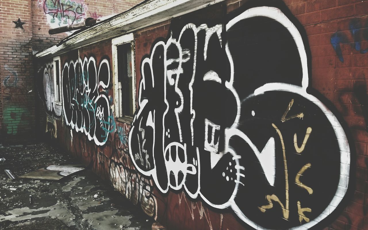 text, graffiti, western script, communication, architecture, built structure, wall - building feature, building exterior, art, capital letter, art and craft, creativity, street art, sign, vandalism, wall, human representation, outdoors, information, no people
