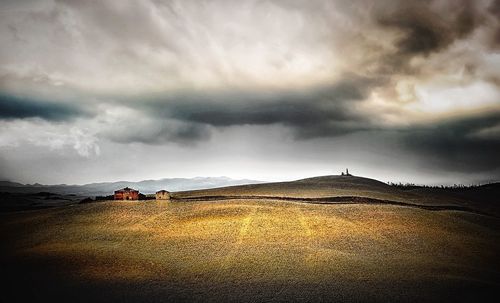 Scenic view of landscape against dramatic sky