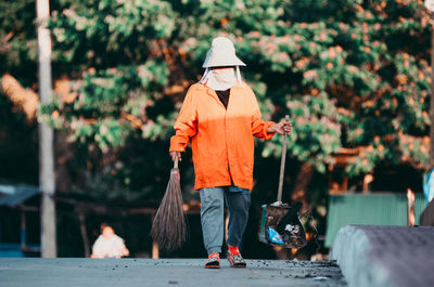 Rear view of man standing by plants