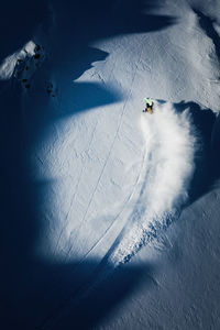 Aerial photo of adult woman backcountry powder skiing in gastein, salzburg, austria