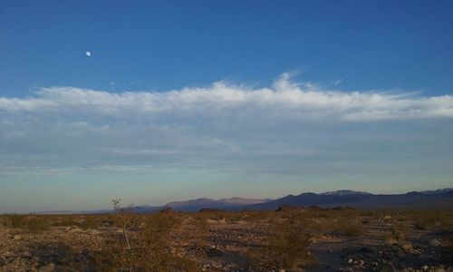 Scenic view of mountains against cloudy sky