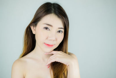 Portrait of a smiling young woman over white background