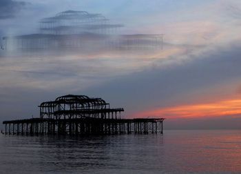 Pier on sea at sunset