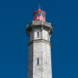 Low angle view of lighthouse against clear blue sky