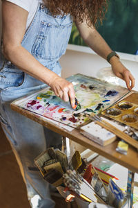 Mid section of painter in studio