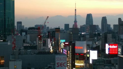 Illuminated cityscape against sky at night