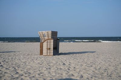 Lifeguard hut on beach against clear sky