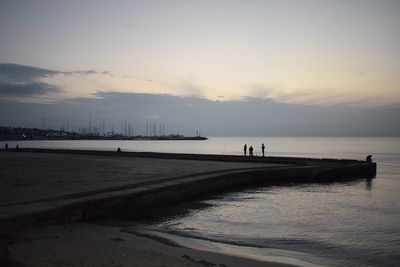 Scenic view of beach against sky during sunset