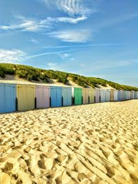 Scenic view of beach against blue sky