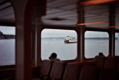 Cruise sailing in sea seen through window