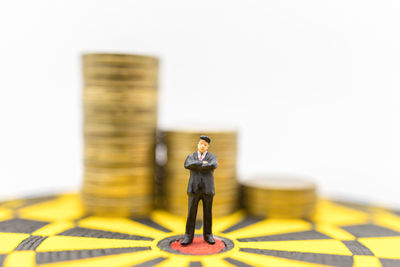 Woman with toy standing on table against white background