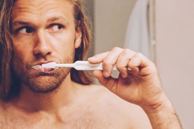 Close-up of man holding cigarette