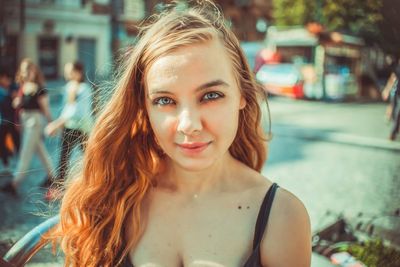 Portrait of a smiling young woman in city