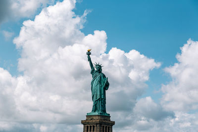 Low angle view of statue against cloudy sky