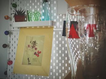 Close-up of paper hanging on glass table