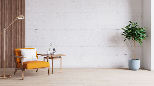 Potted plant on table against wall