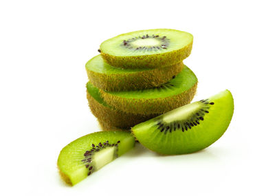 Close-up of green fruit against white background