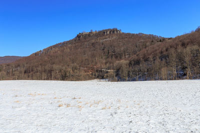 Scenic view of mountains against clear blue sky