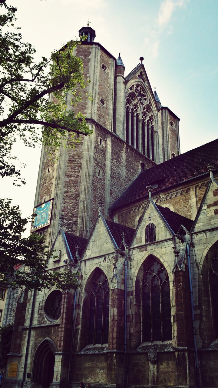 architecture, building exterior, built structure, low angle view, church, religion, place of worship, spirituality, sky, arch, window, facade, cathedral, cross, old, day, outdoors, no people