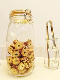 Close-up of cookies in glass jar on table