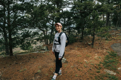 Portrait of young man standing in forest