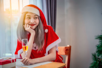 Portrait of young woman in drinking glass