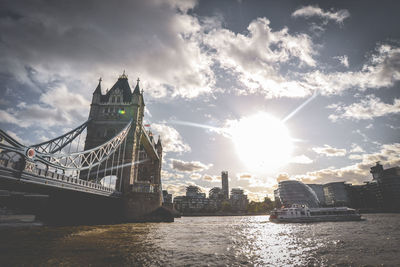 View of bridge over river against cloudy sky