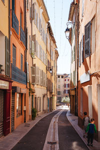 People walking on street amidst buildings in city