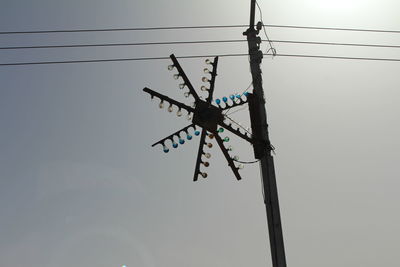 Low angle view of electricity pylon against sky