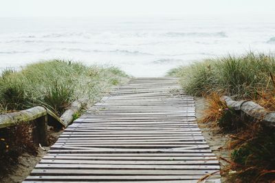 Wooden boardwalk leading to sea