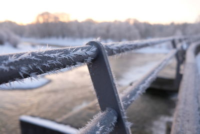 Close-up of rope against fence during winter