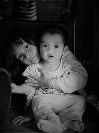 Portrait of sisters sitting at home