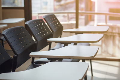 Empty chairs arranged in row