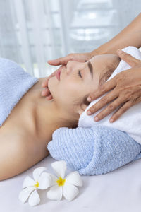 Masseur massaging woman in spa