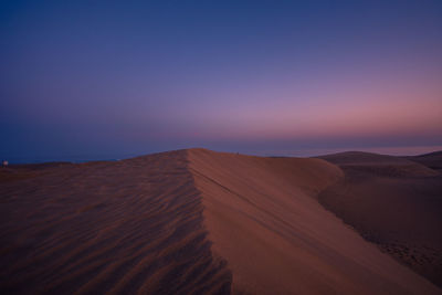 Scenic view of desert against sky during sunset