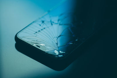 High angle view of glass over blue background