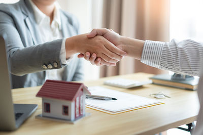 Midsection of businessman shaking hands