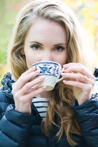 Portrait of a beautiful young woman drinking water