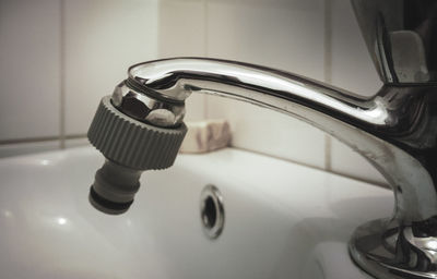 Close-up of faucet in bathroom