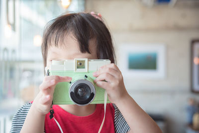 Close-up of girl photographing