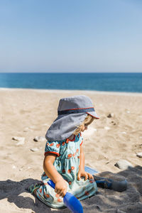 Cute girl sitting at beach