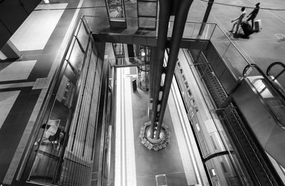 Low angle view of man walking on escalator