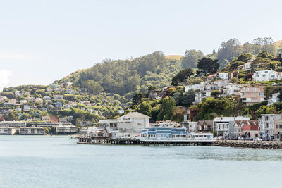 Townscape by sea against clear sky